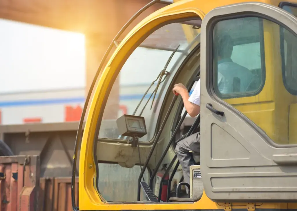Crane operator lifting equipment during a permitted crane move in NYC